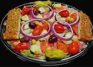 salad with cherry tomatoes, cucumbers, olives, croutons, red onion rings, and banana peppers