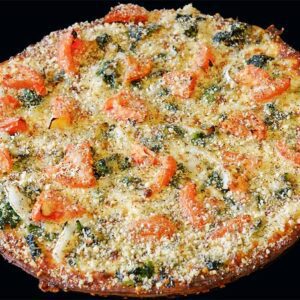 round gluten free pizza with tomato, spinach and cheese